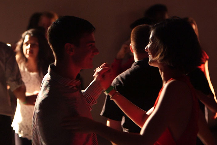 Two people salsa Dancing together on a dance floor