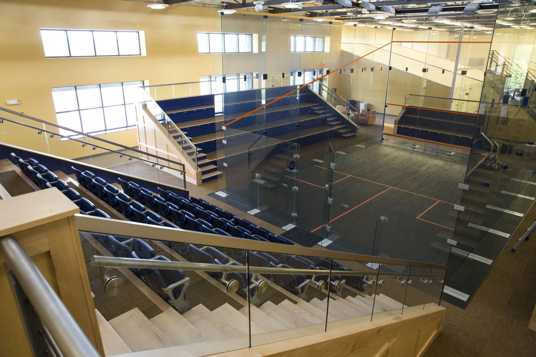 Glass Squash court surrounded by bleachers