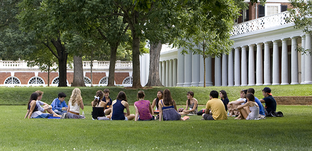 Students sit on the lawn in a circle