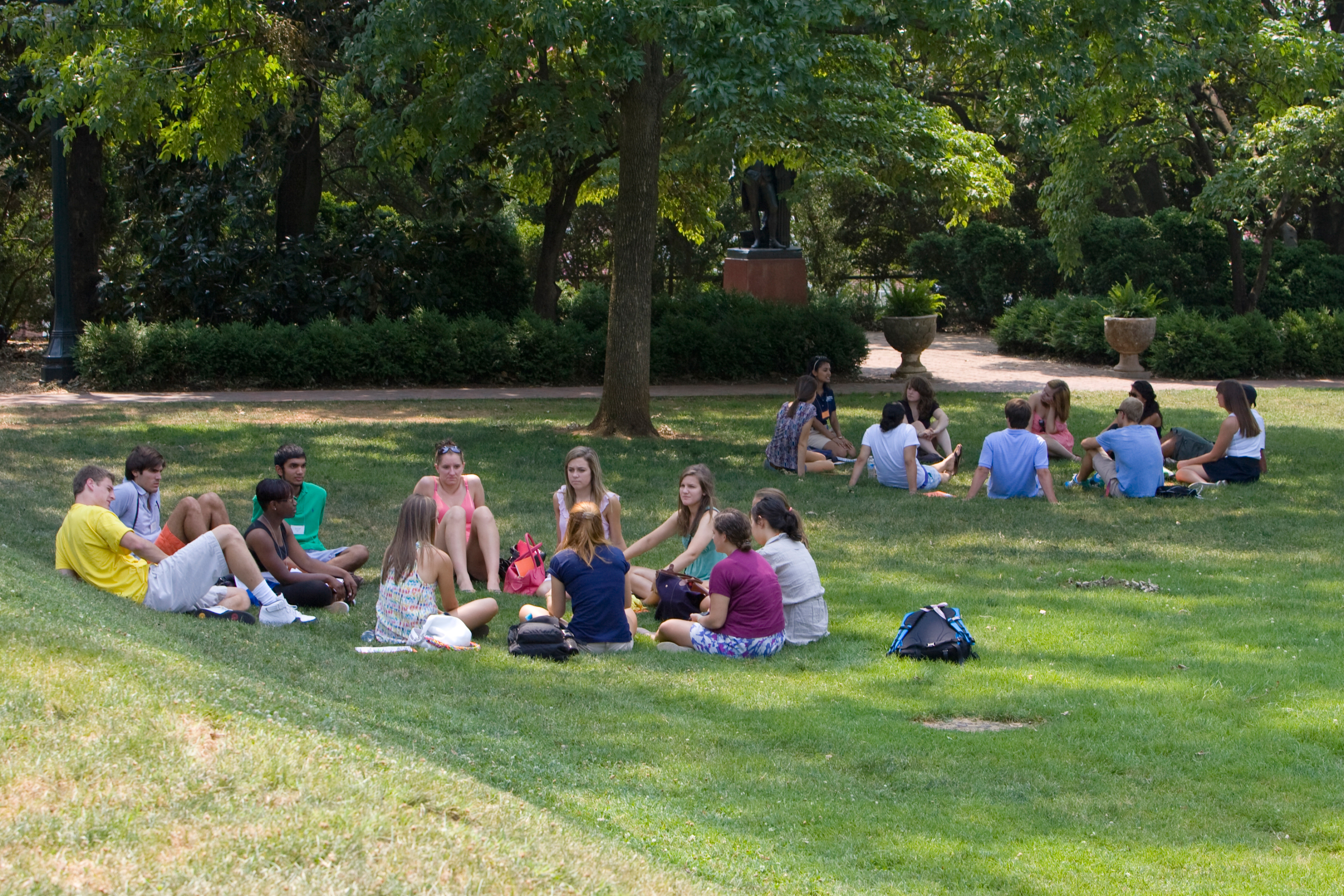 Students sitting in circles on the grass
