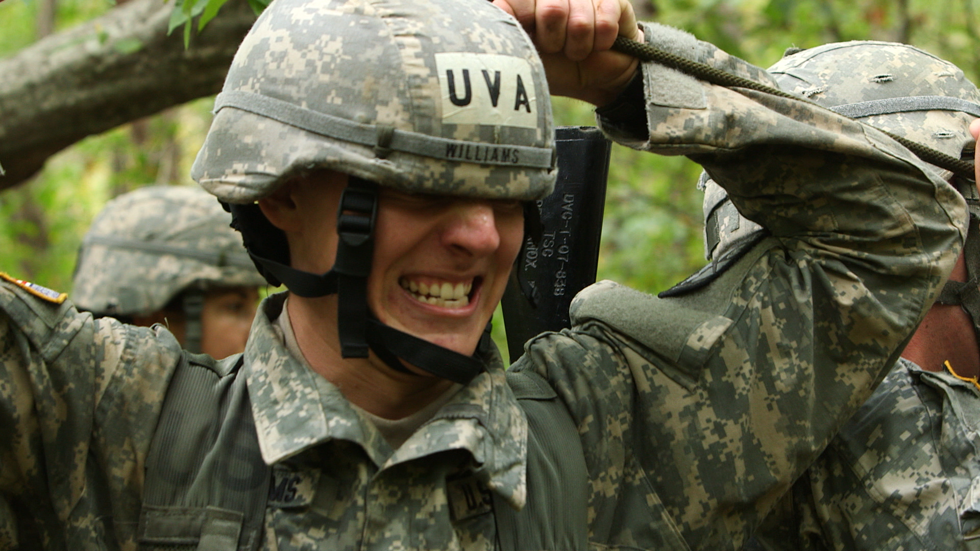 Williams in Military uniform with tape on his helmet that reads UVA during a bootcamp ROTC course