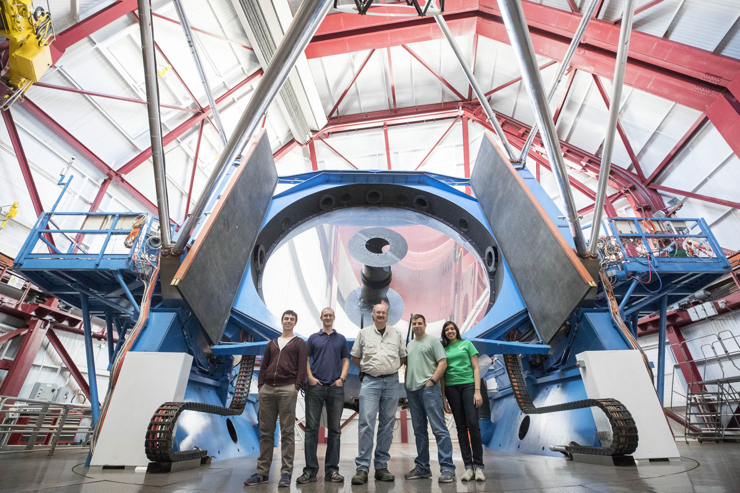 A UVA team in Chile stands in front of the APOGEE astronomical instrument.