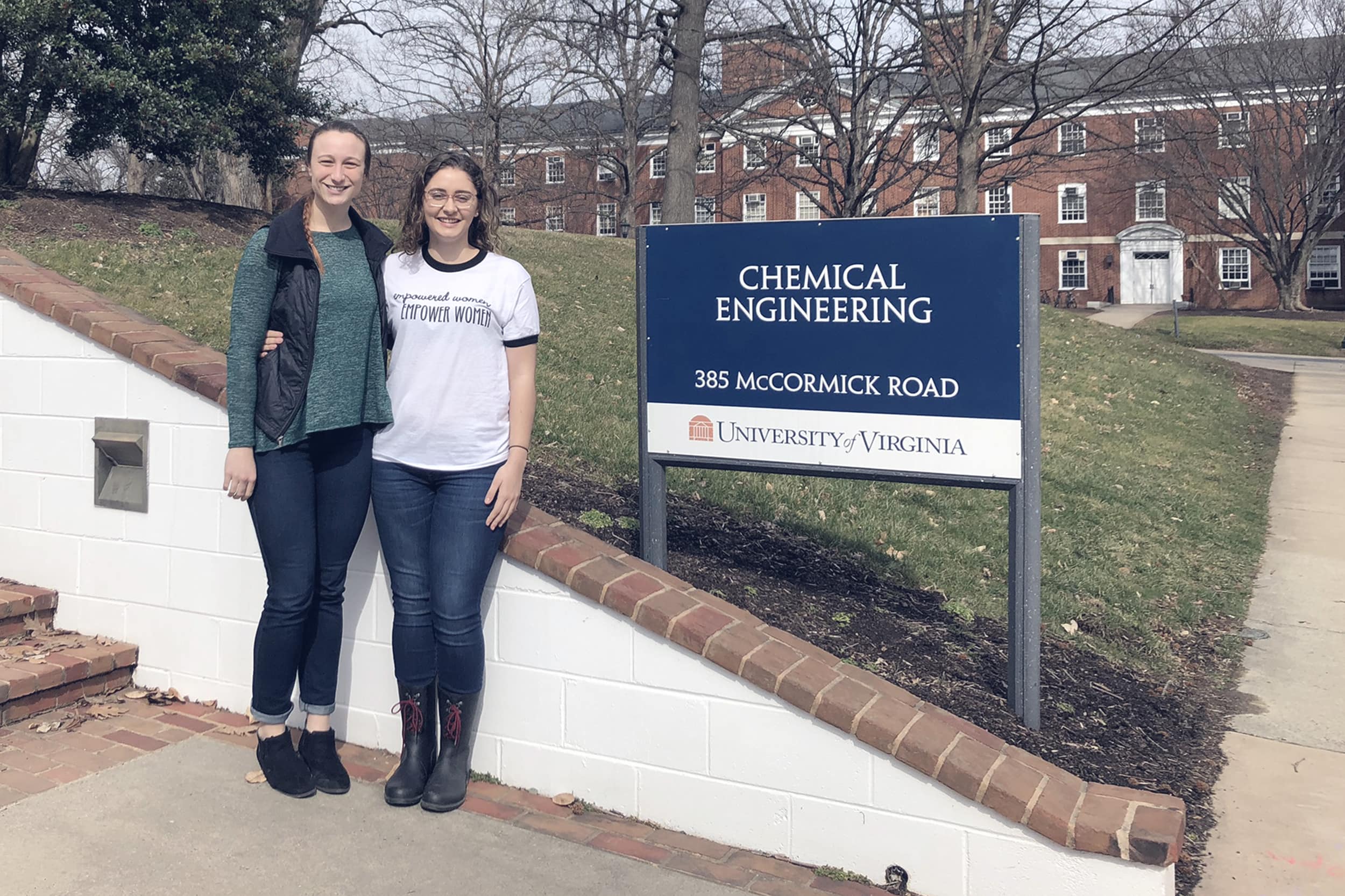 Bev Miller, left, and Rebecca Earhart stand next to the Chemical Engineering building sign for a picture