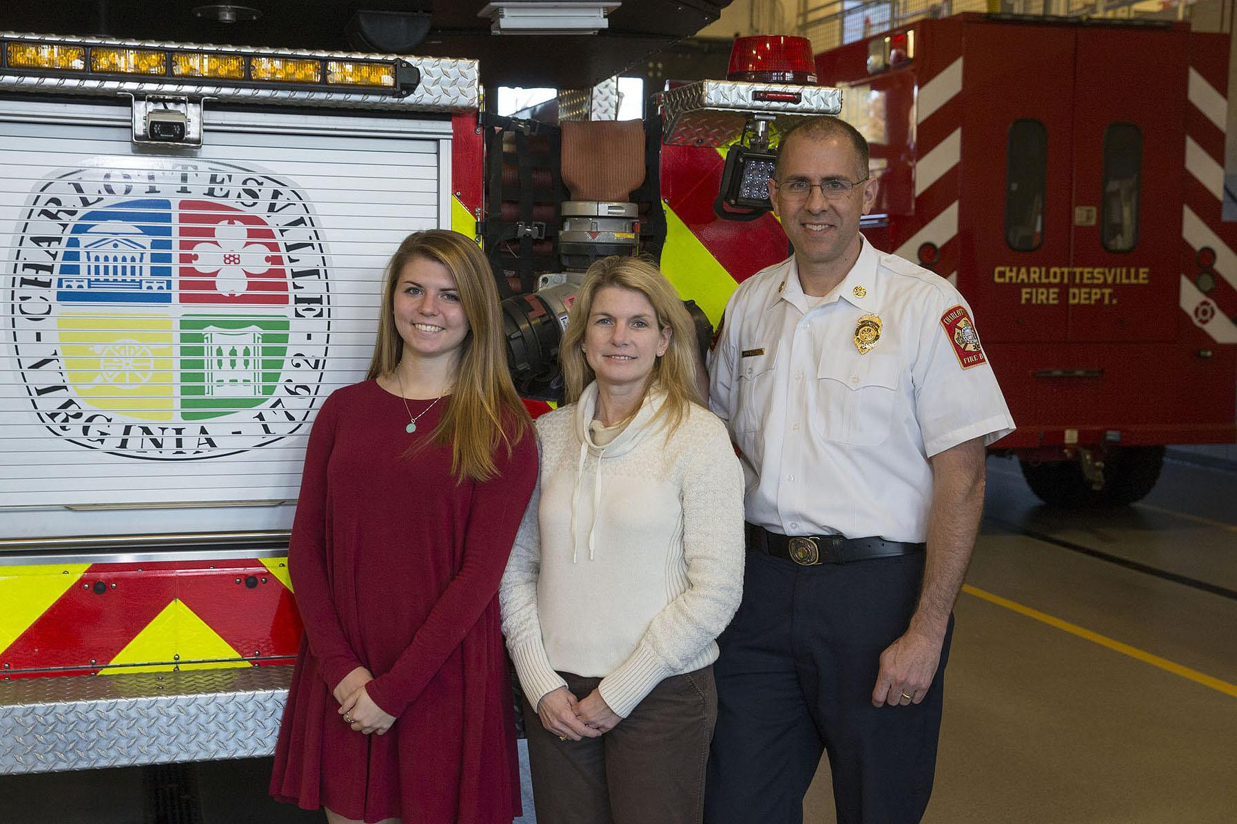 Andrew Baxter, right, stands with his daughter, Kate, left, and wife, Barbara, at a firetruck