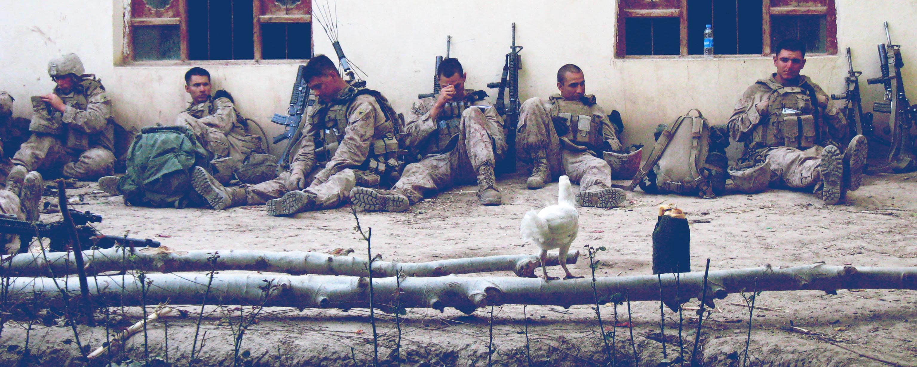 USA Marines from India Company’s 1st Platoon, resting in the courtyard of a wealthy Afghan’s compound, grieve after the death of LCpl Jordan Bastean during Operation Southern Strike.