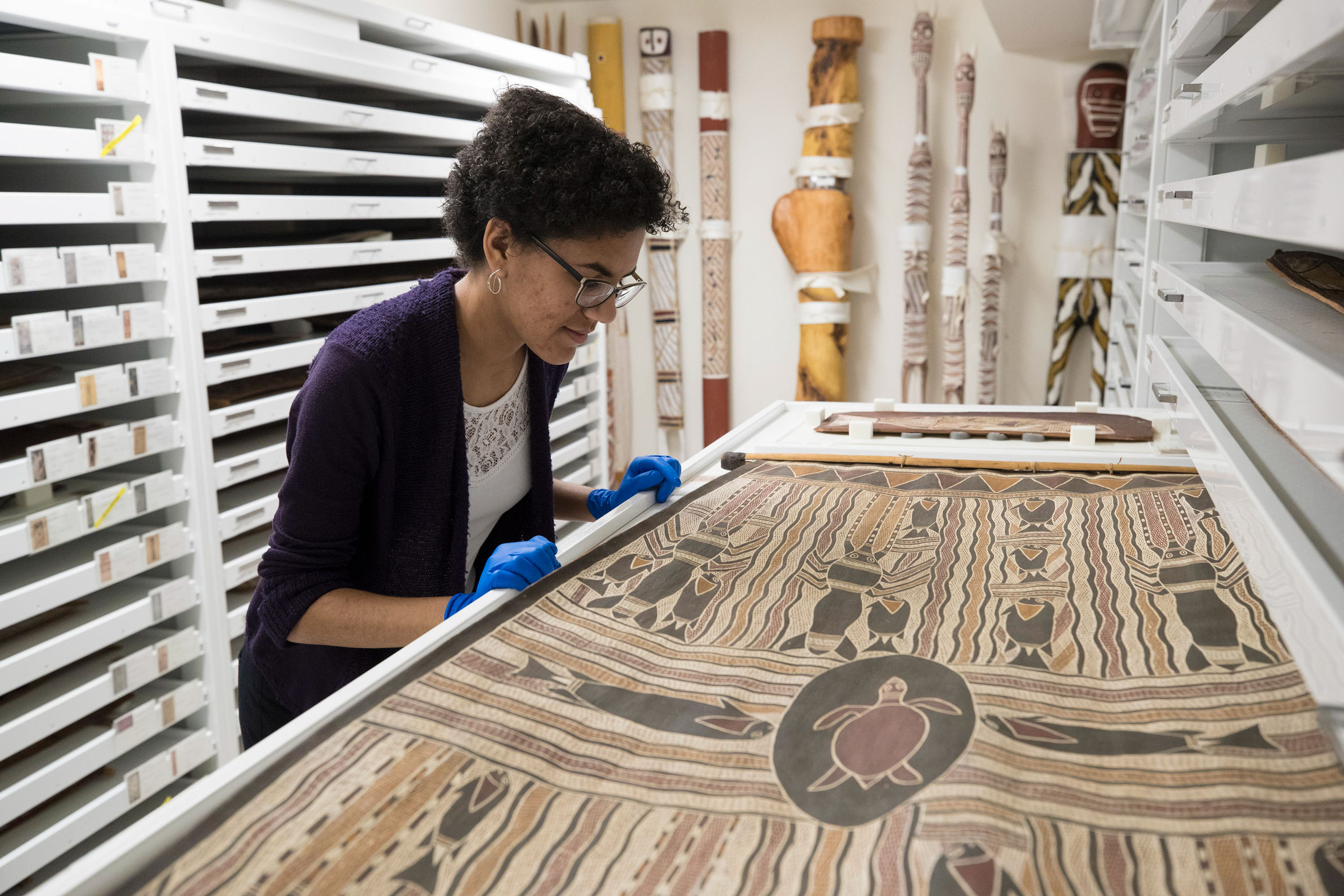 Gabby Fuller examining a piece of Aboriginal art