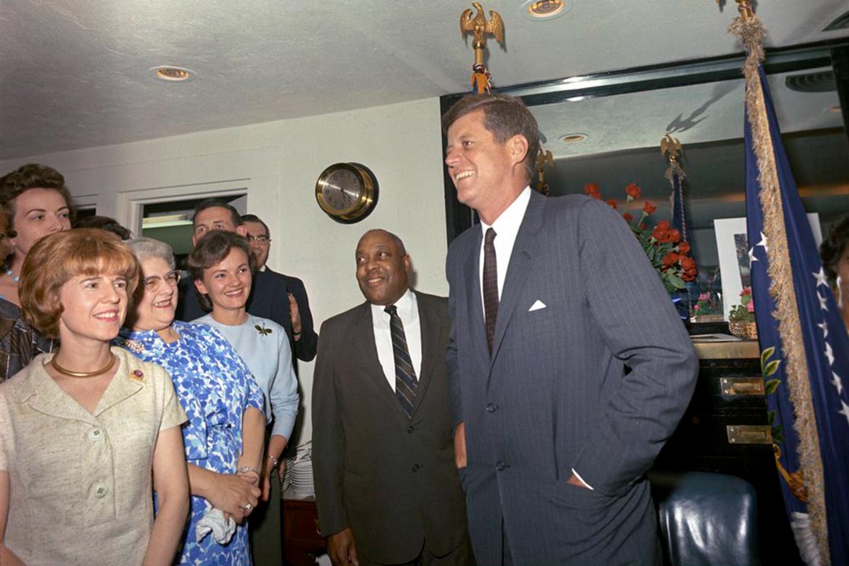 George Thomas, center, with President Kennedy surrounded by a group of people