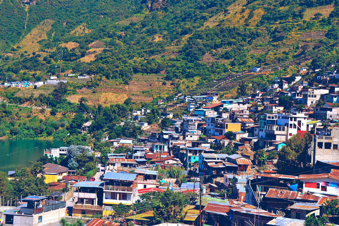 Aerial view of houses in a third world country.  Houses have metal roof and are various colors