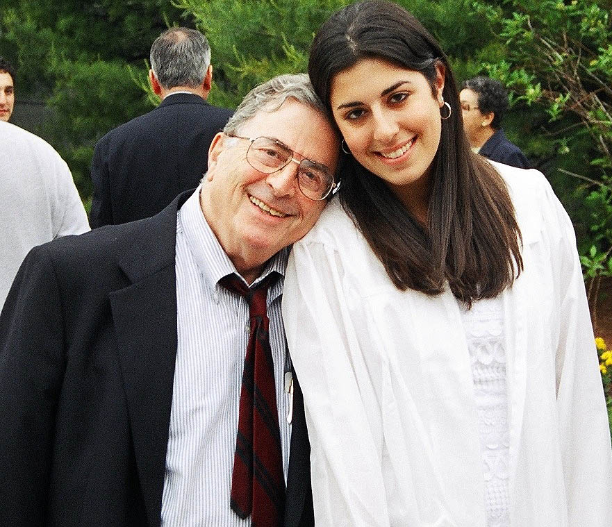 Bert Sachs and granddaughter Shira Furman stand next to each other smiling at the camera