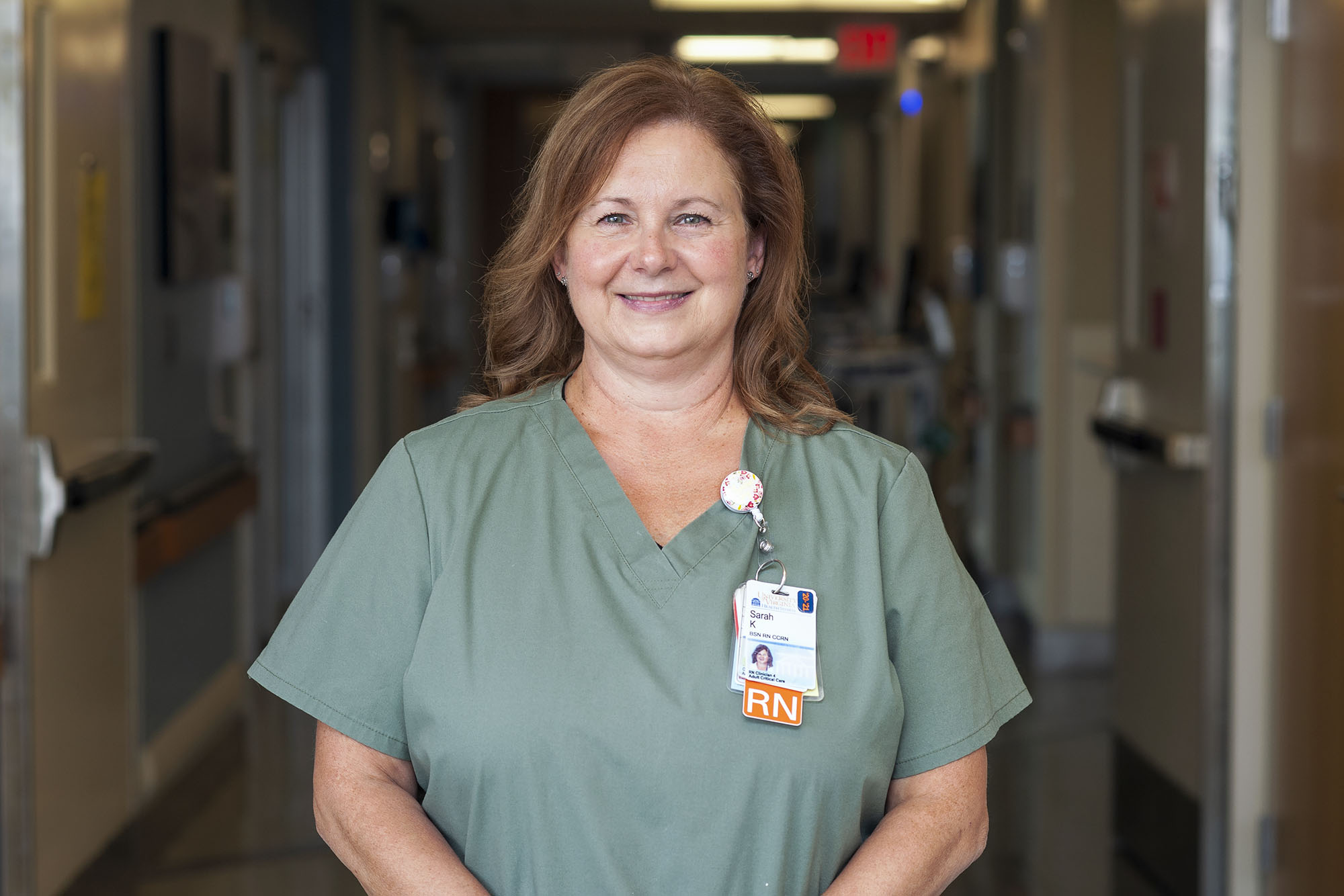 Sarah Kaplan headshot in green nursing shirt