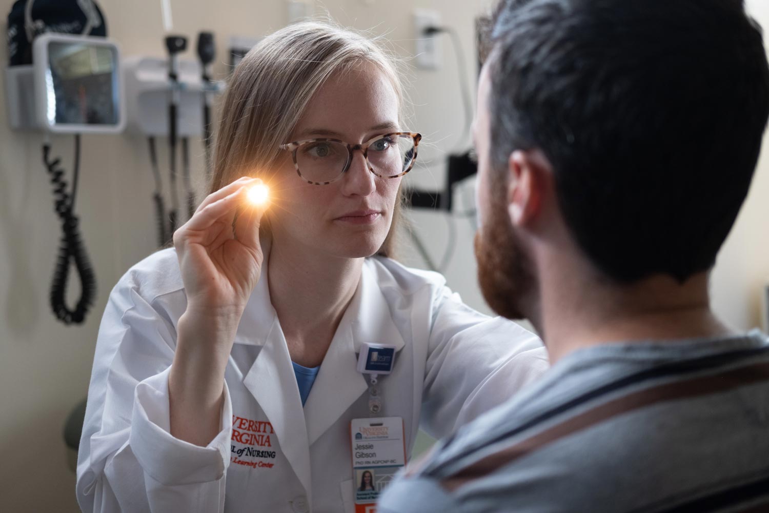 Medical Professional shining a light into the eyes of a patient