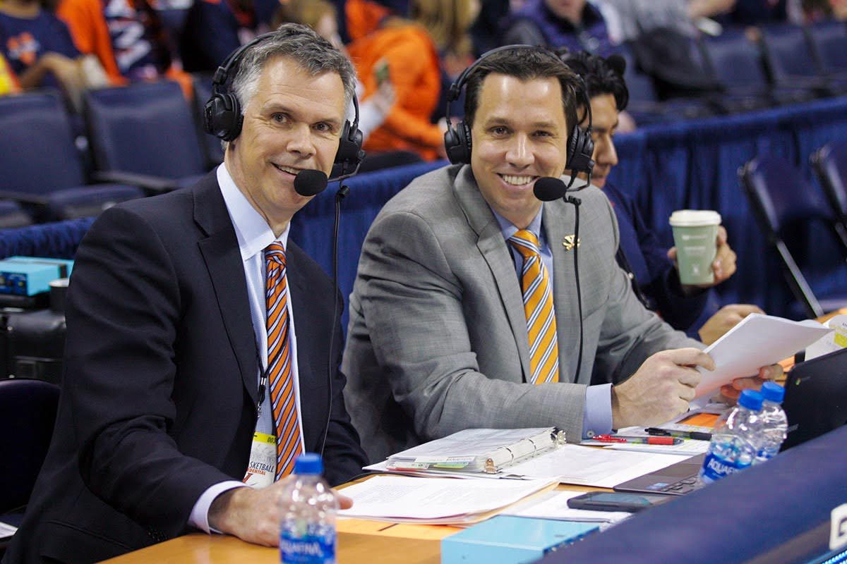 Jimmy Miller, left, and Dave Koehn, right, wearing headsets commentating the UVA basketball game