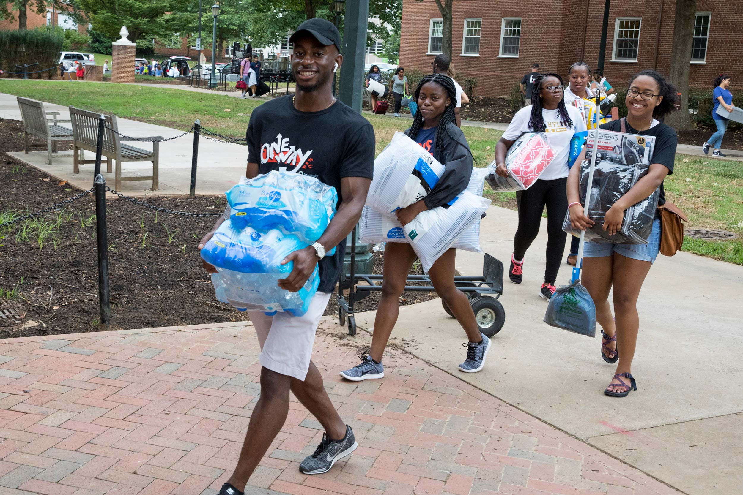 Students carrying their belongings into their dorms