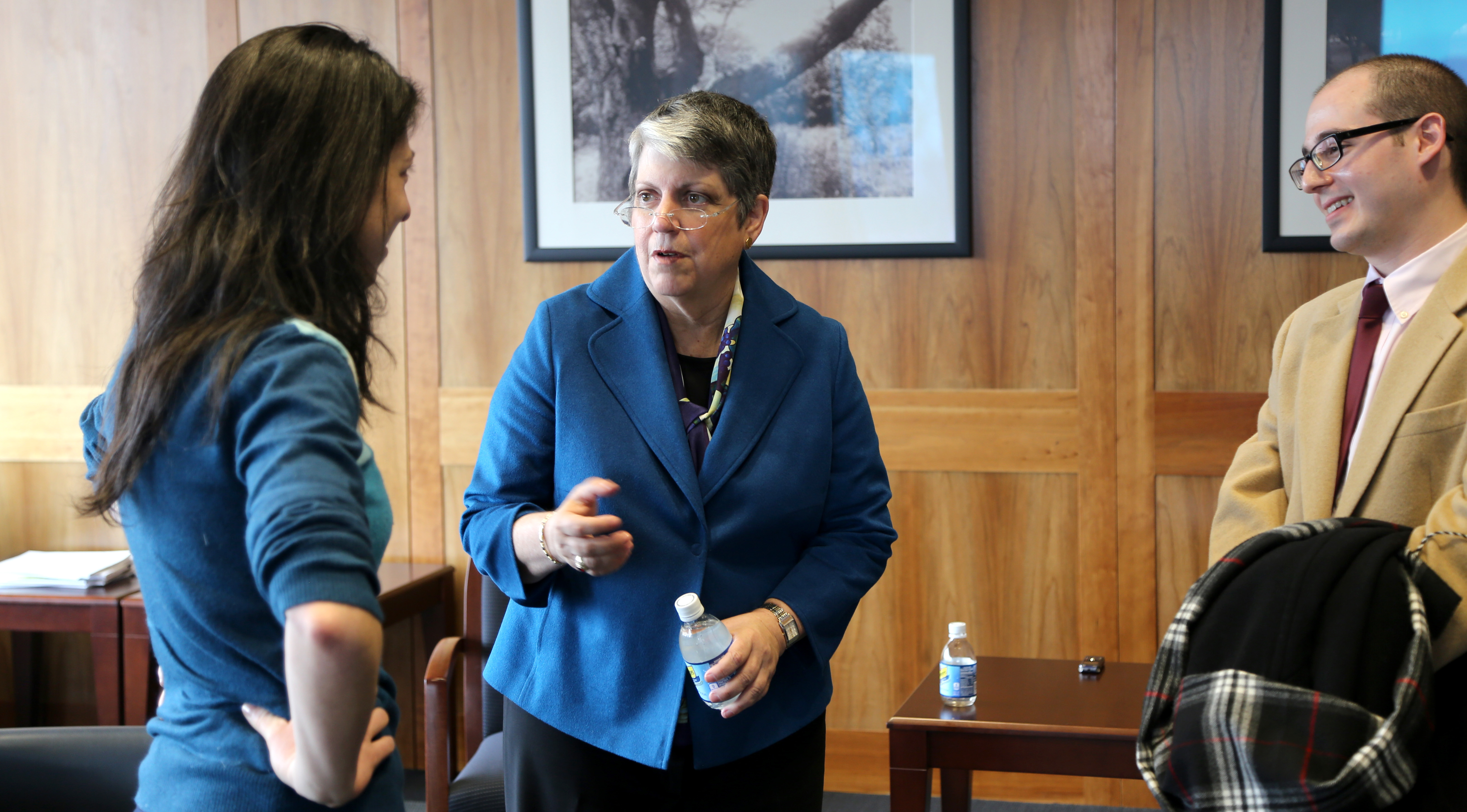 Janet Napolitano talks to a woman in her office