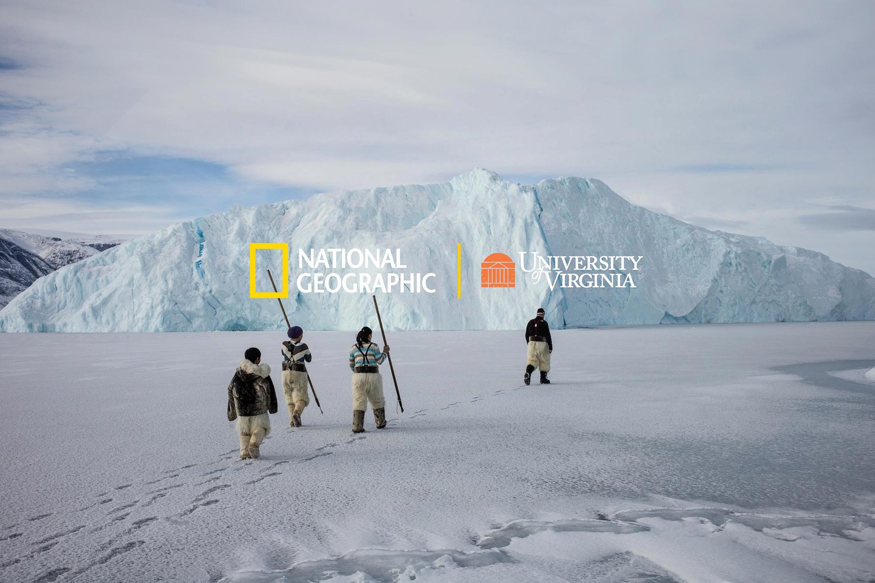 Four people walking across the snow to a big iceberg with the text: National Geographic | University of Virginia