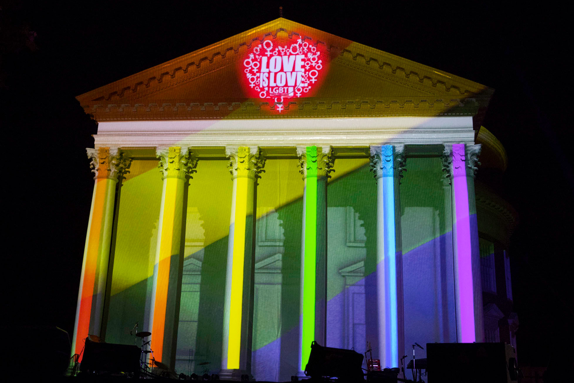 The Rotunda lit up in rainbow colors with text that reads Love is Love LGBT over the clock