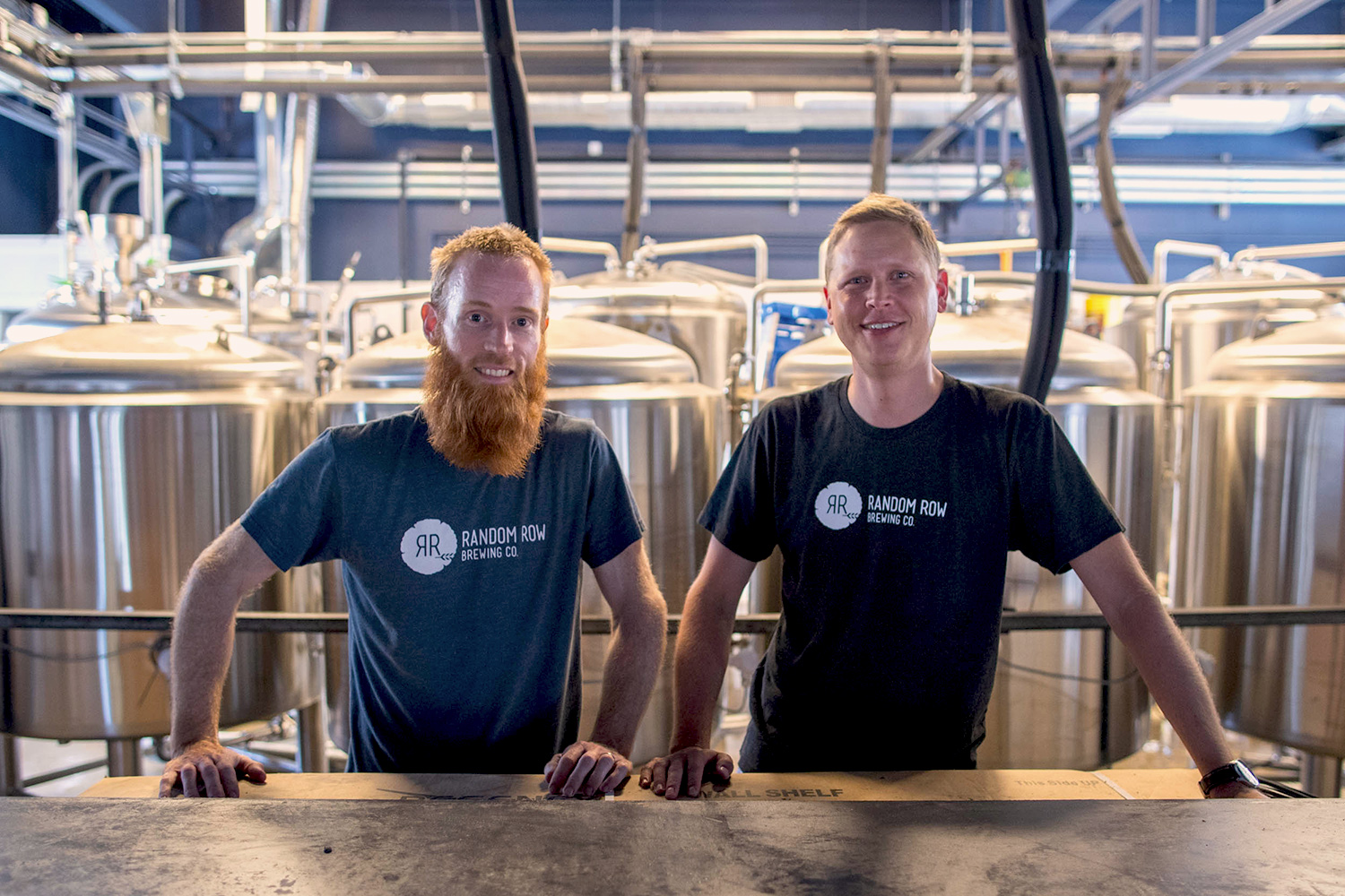 Kevin McElroy, left, and Bradley Kipp stand behind the bar at Random Row Brewing Co