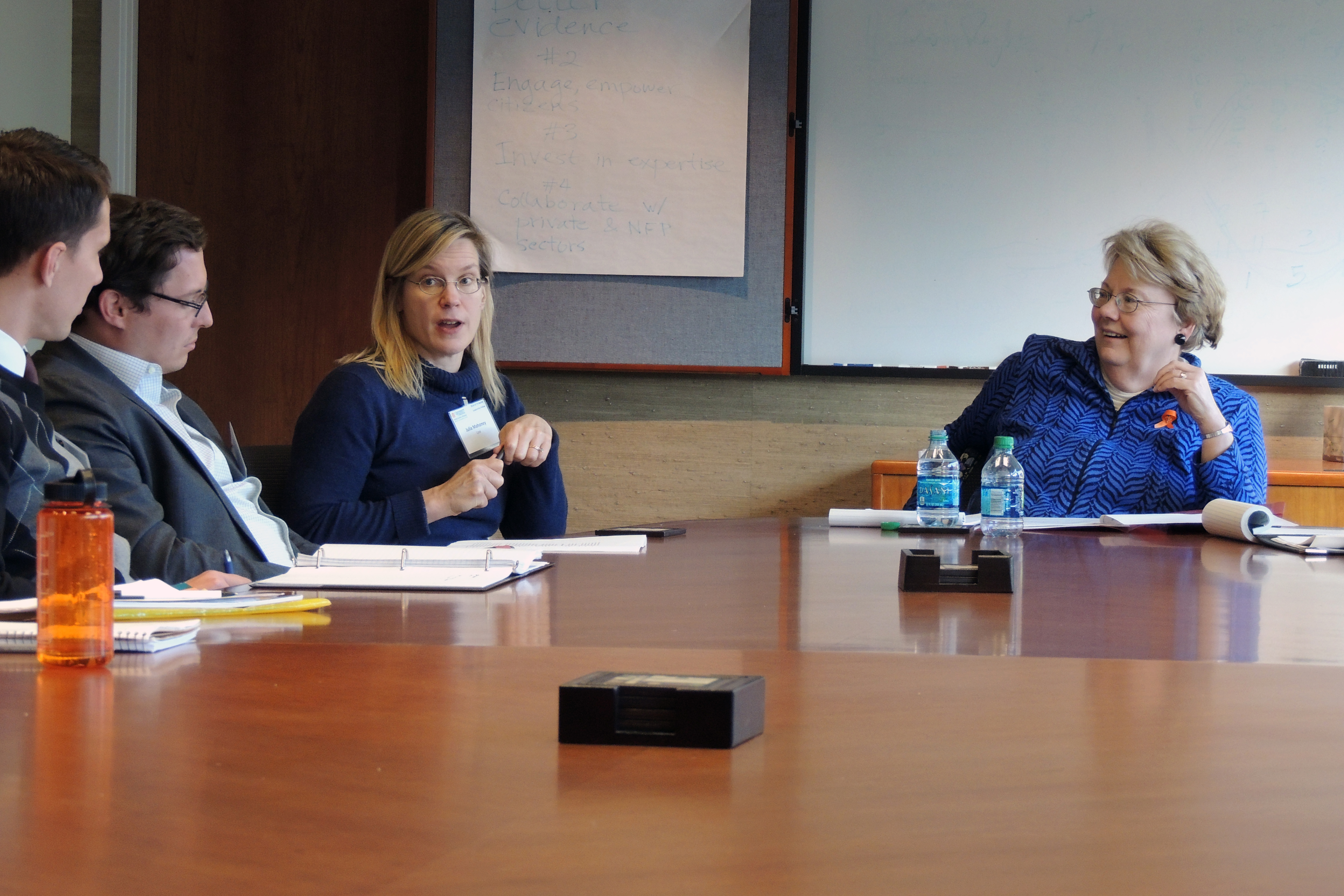 President Sullivan (right) and law professor Julia Mahoney (center) talking to a group of people