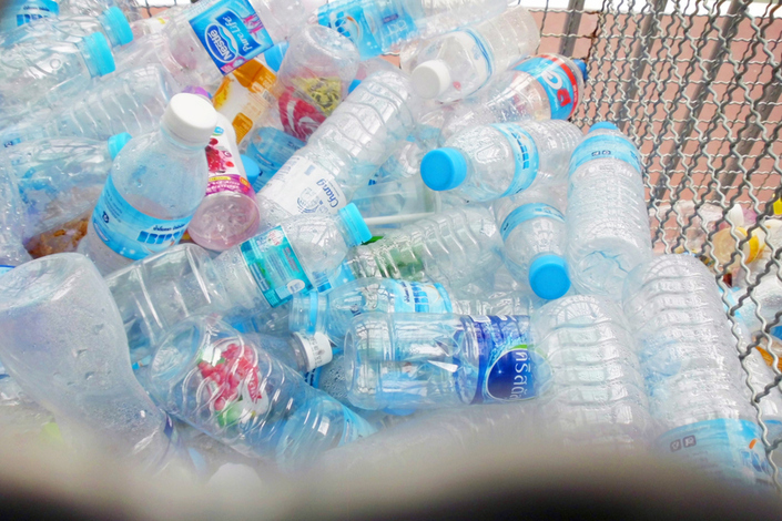 Plastic water bottles in a metal bin