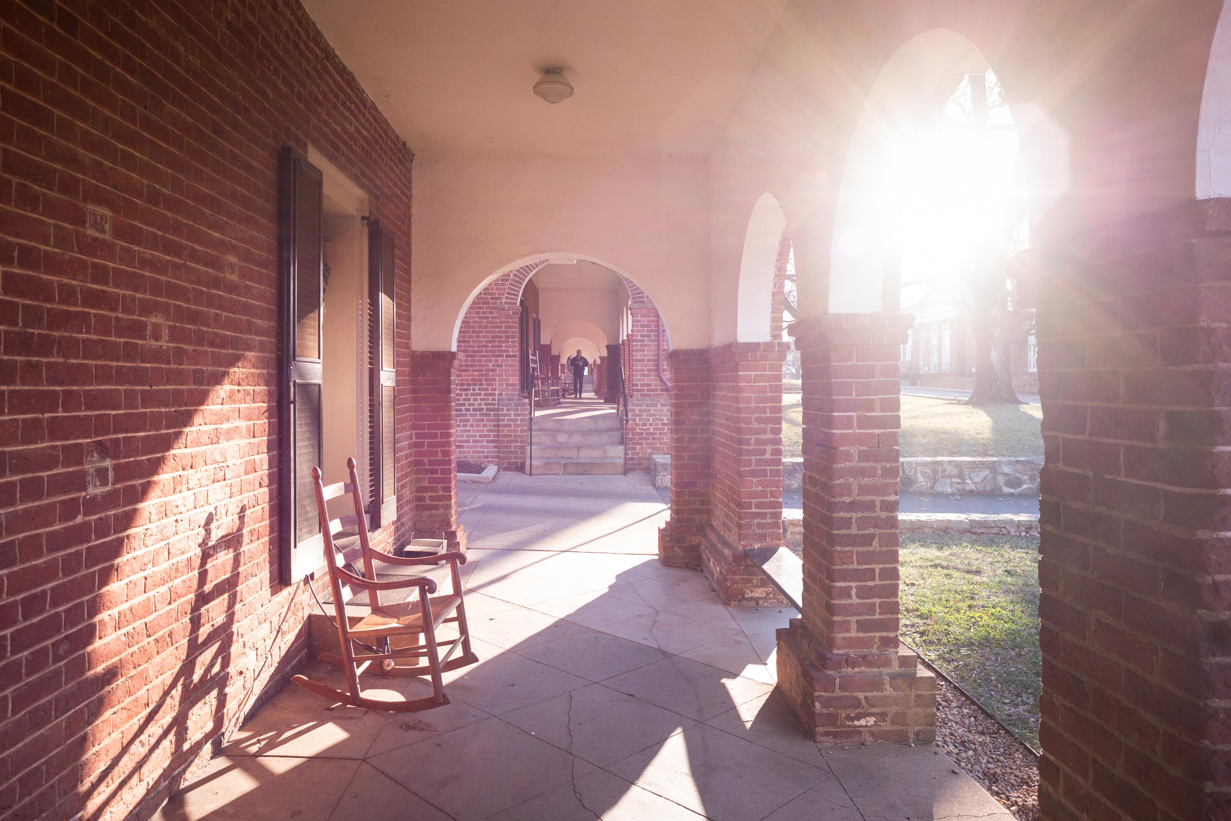 The Lawn arched walkways as sun peaks through the arches