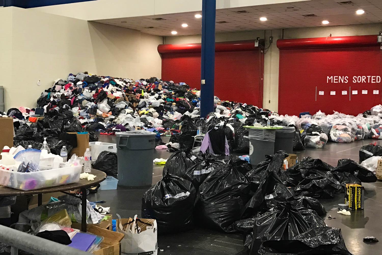 Mounds of donations of clothes at a Houston shelter.
