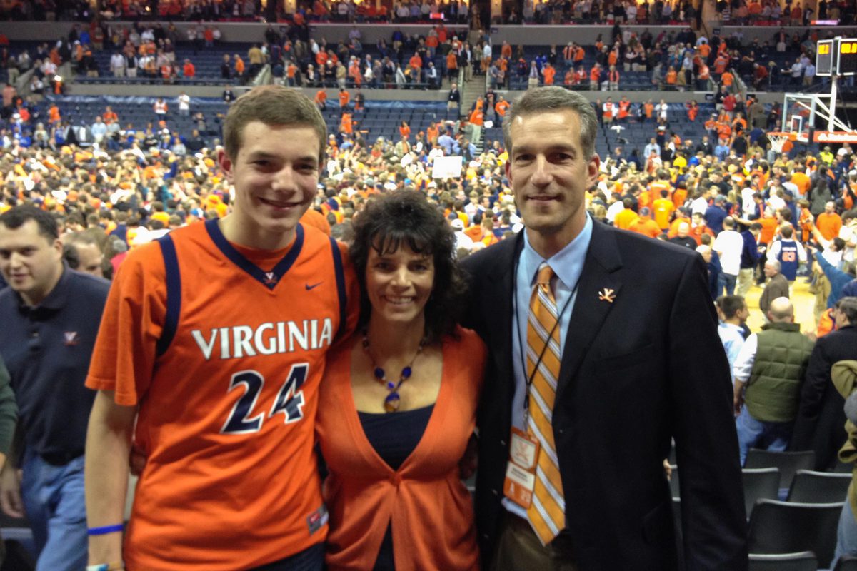 Austin Katstra,  his father, Dirk, and his mother, Michelle, stand together for a photo after a UVA basketball game