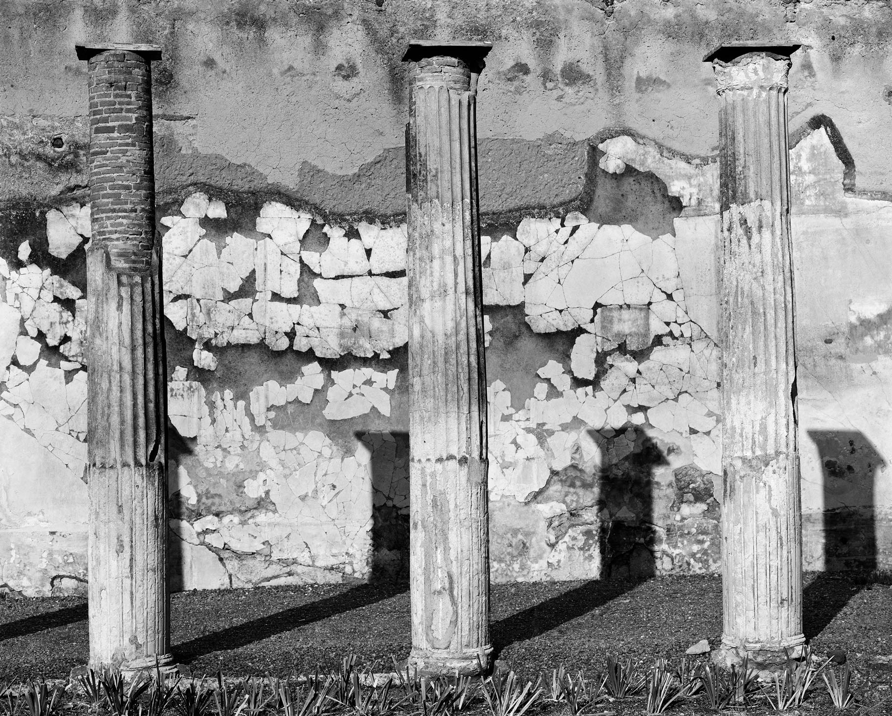 Pillars and broken wall in pompeii, black and white image