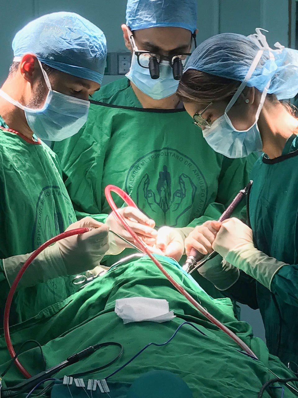 Syed, center, in surgery
