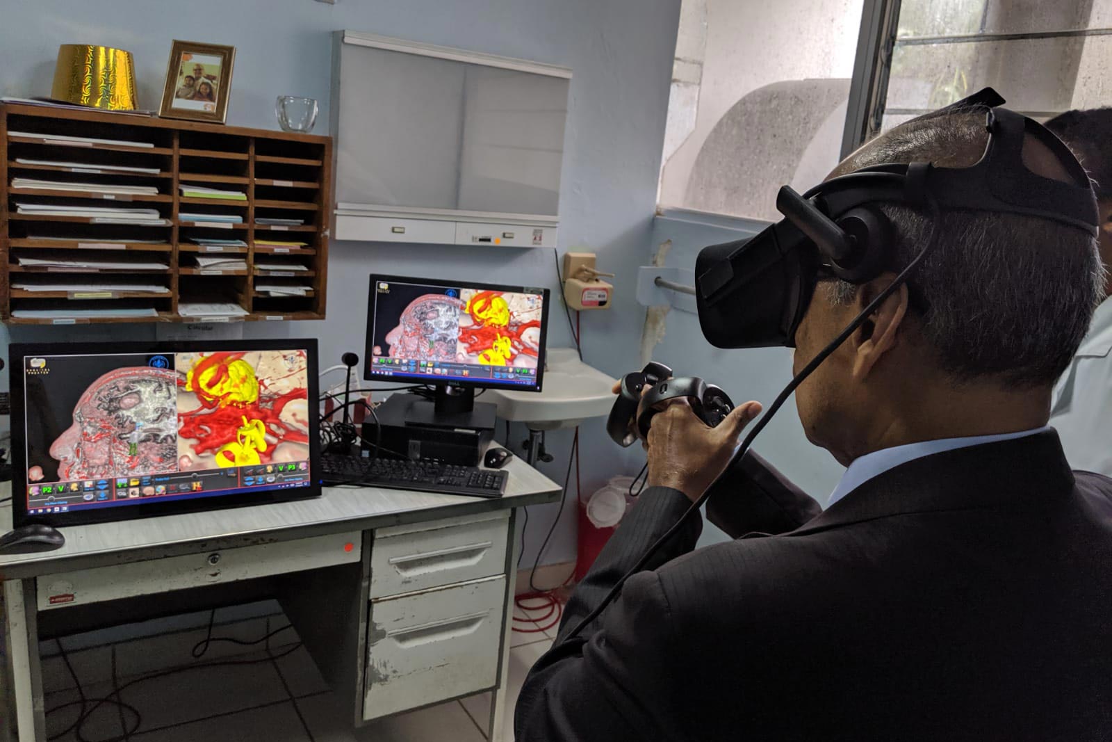 Man using a Virtual Reality system to perform surgery