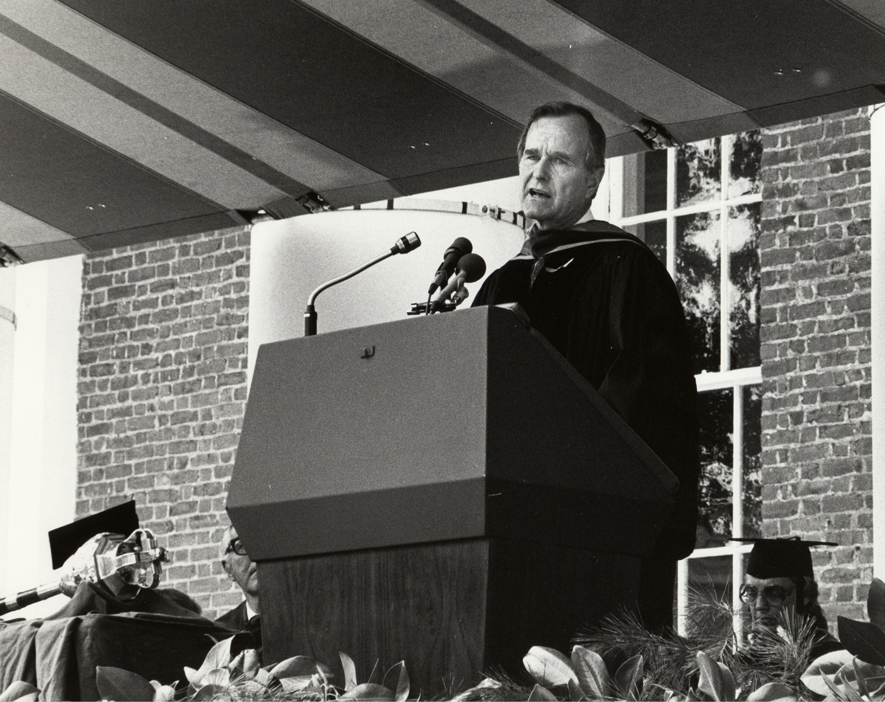 George HW Bush speaking at a podium