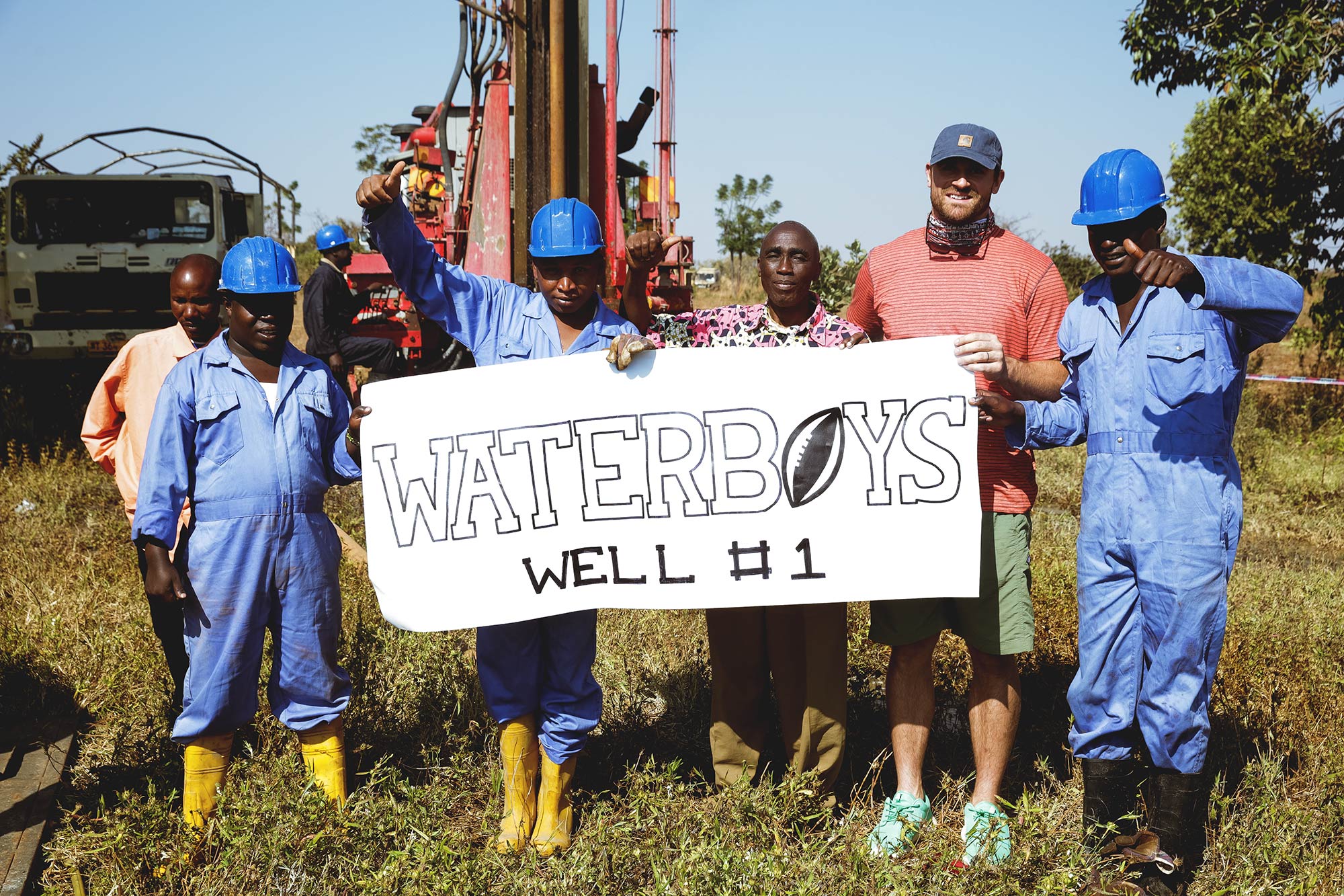 Chris Long, right, celebrates with workers after completing the first well. 