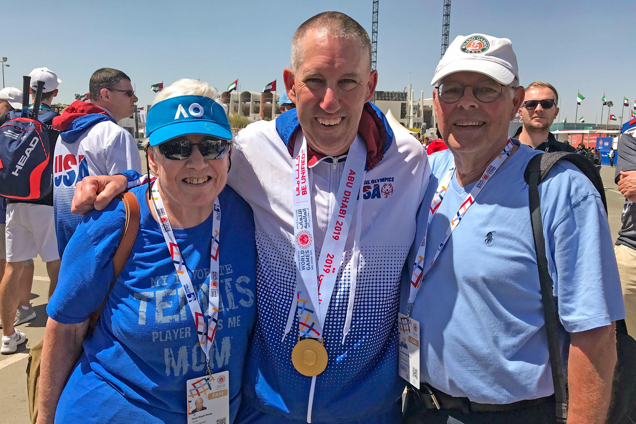 Raupp celebrates his gold-medal in Abu Dhabi with his parents, Sue and Lloyd.