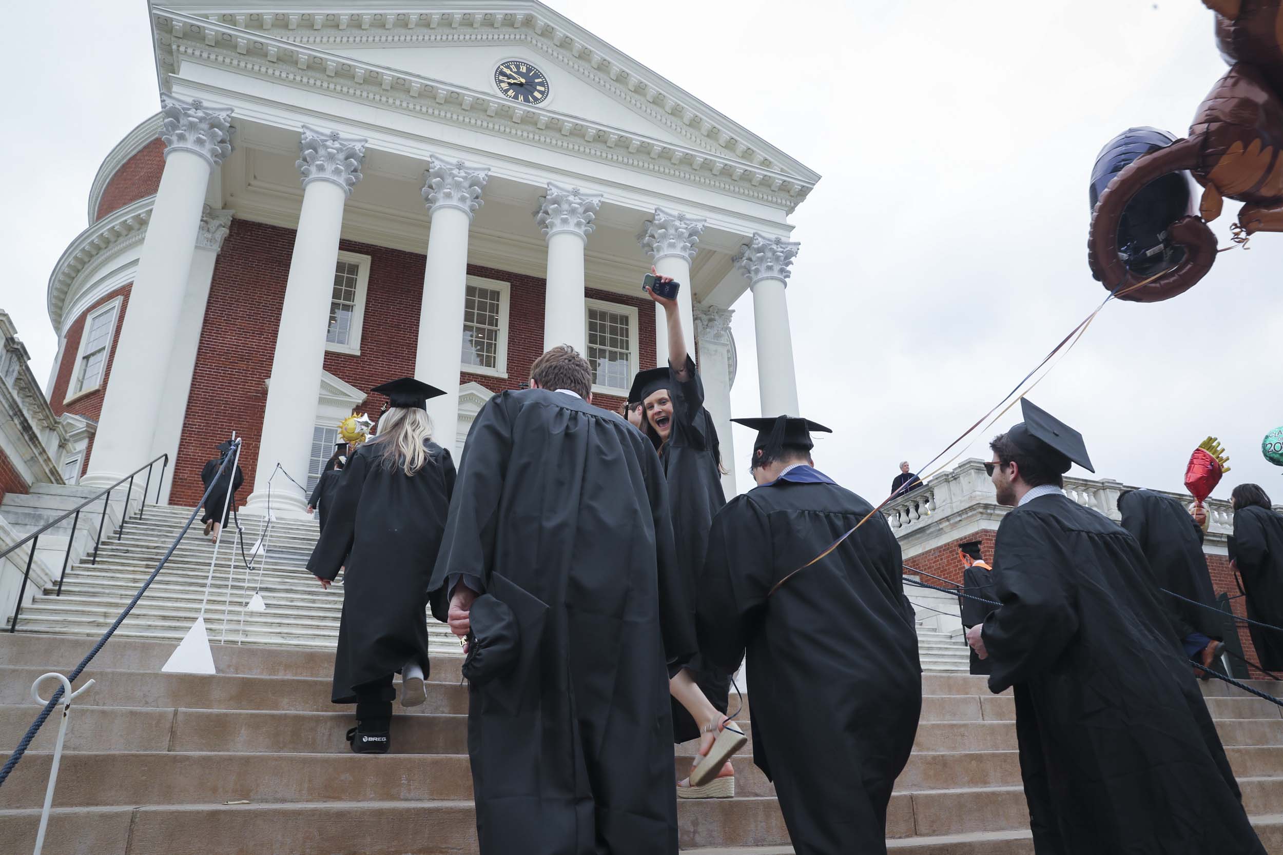 Graduates walking up the steps of the Rotunda