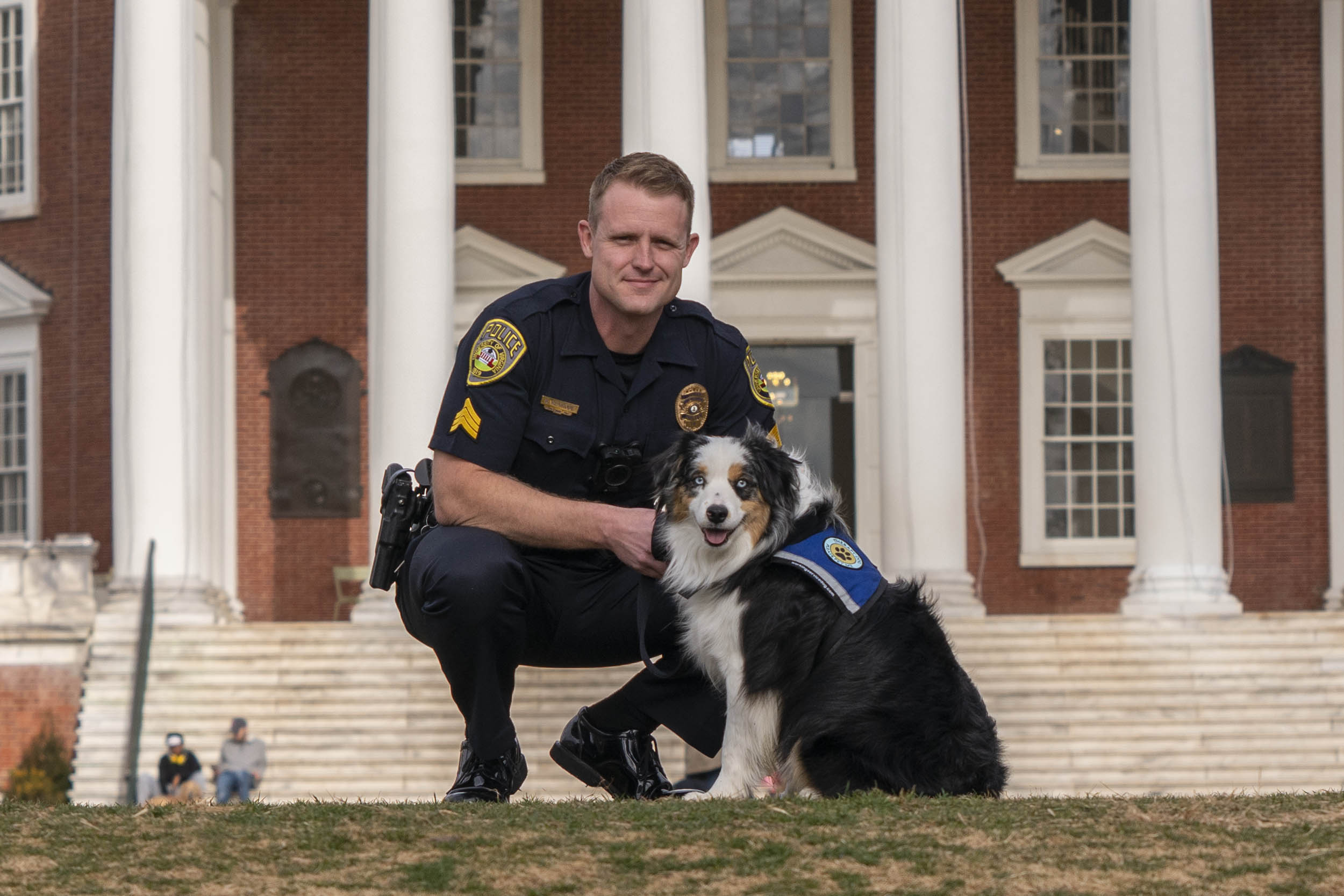 Sgt. Benjamin Rexrode poses with Cooper in front of the Rotunda