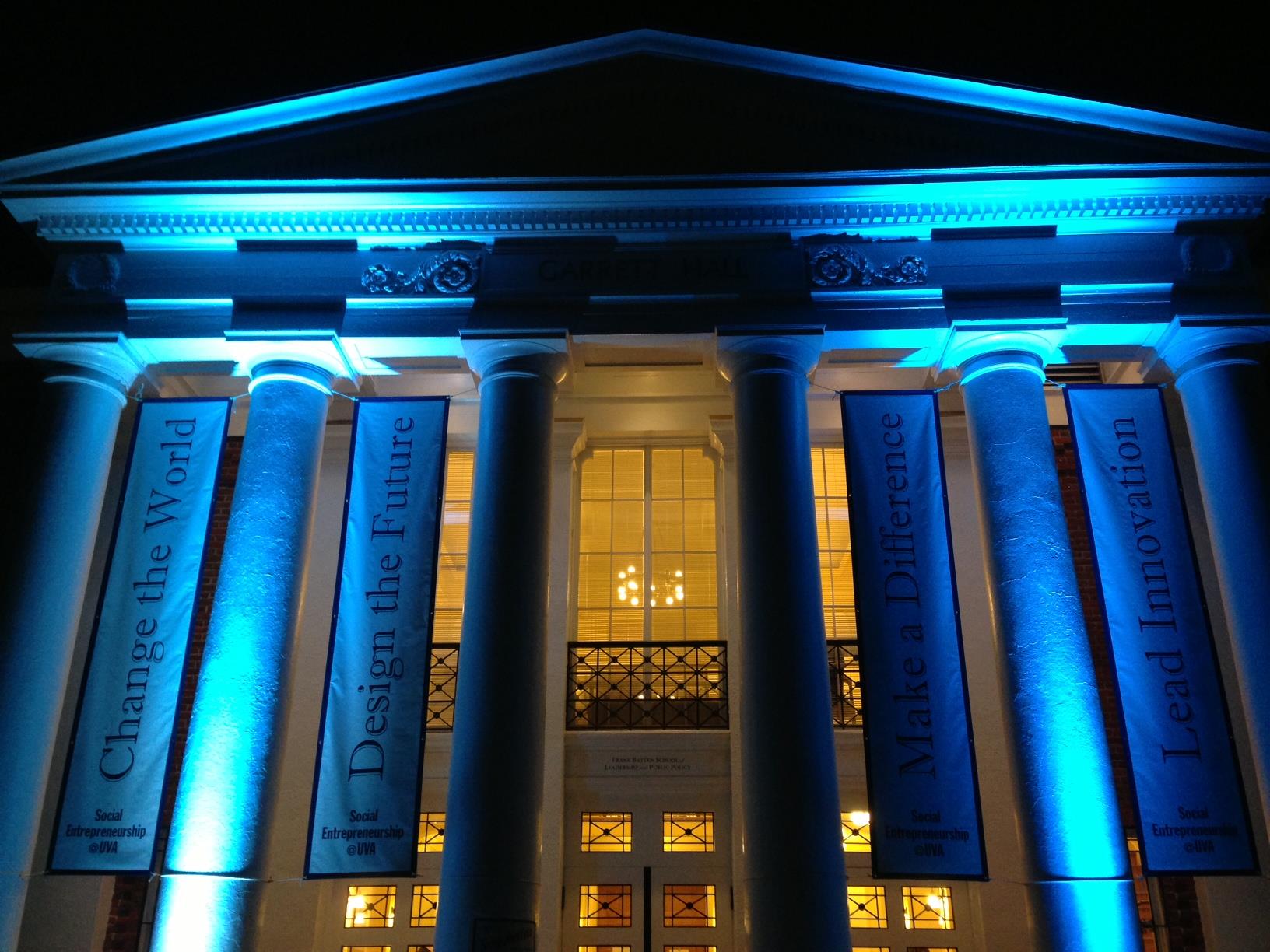 Data Science institute at night with blue lights shining on the pillars