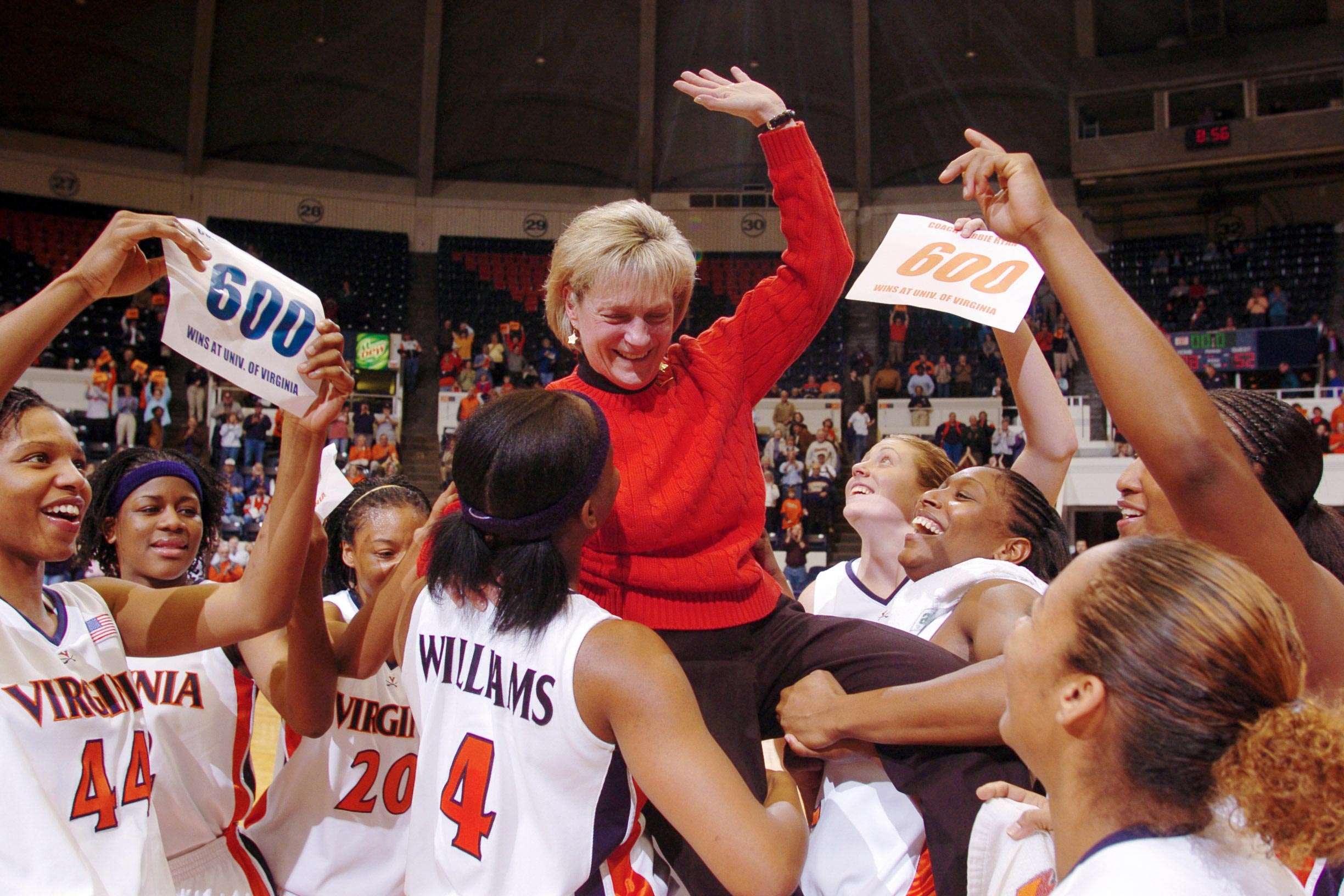 Debbie Ryan being lifted into the air by the Womans basketball team