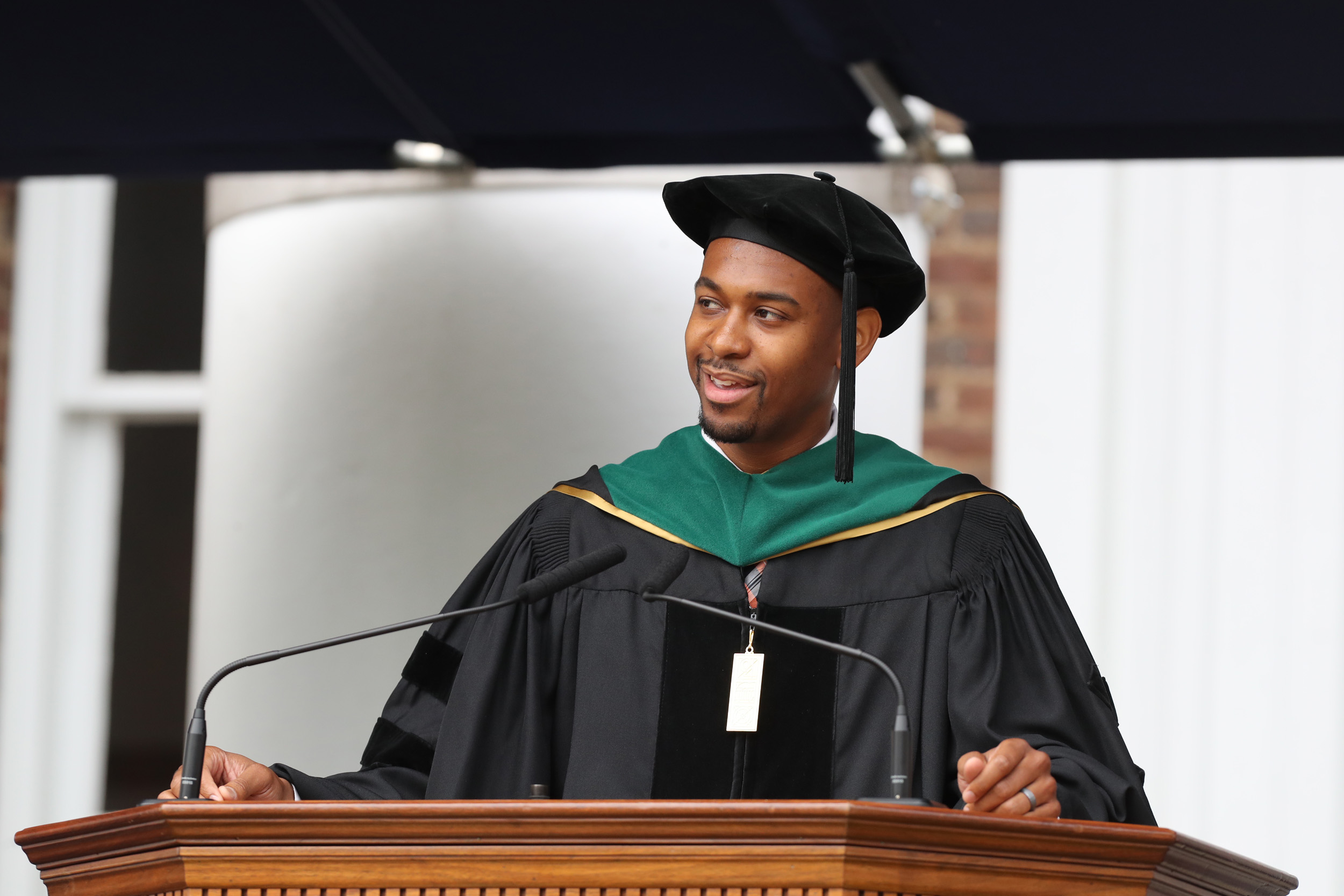Doctorate student standing at a podium during graduation
