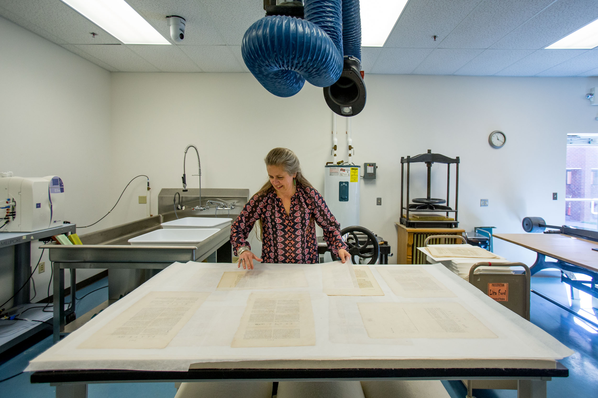 Gilligan lays out newly cleaned pages of Carter’s original volume. Photos by Sanjay Suchak / University Communications