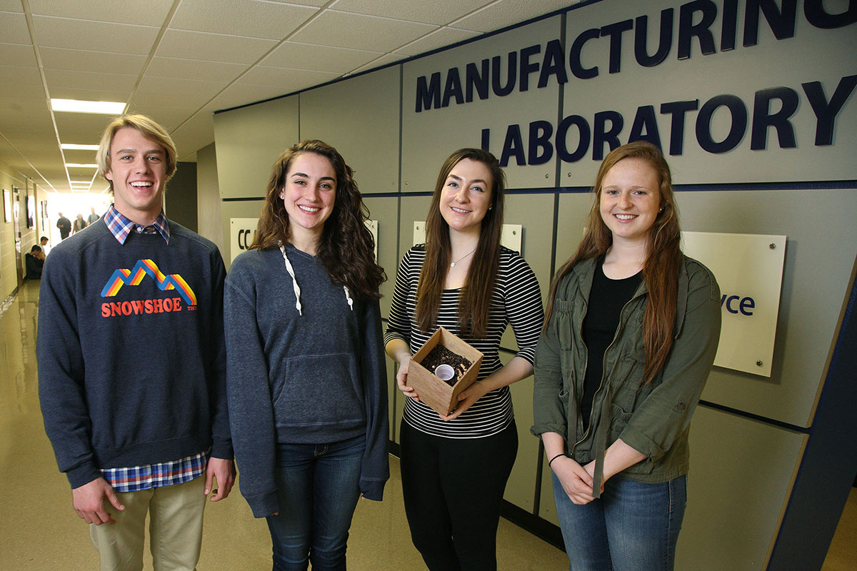 From left, Justin Pender, Audrey Fifer, Caroline Kinsella and Morgan Patterson hold their mushroom spore home insulation, their project for their “Introduction to Engineering” course.
