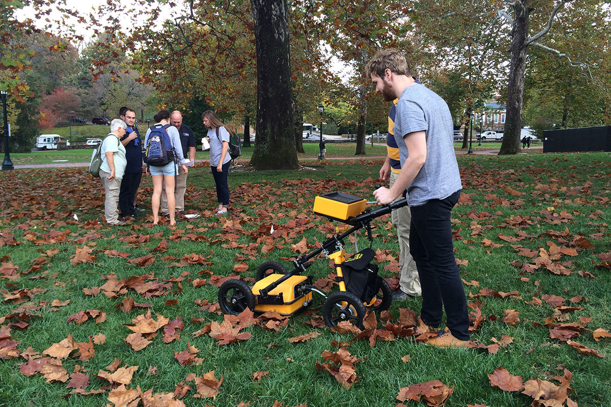 Hutch Landfair, a student in “Field Methods in Historic Preservation,” uses ground-penetrating radar equipment to help identify foundations of now-missing buildings. 