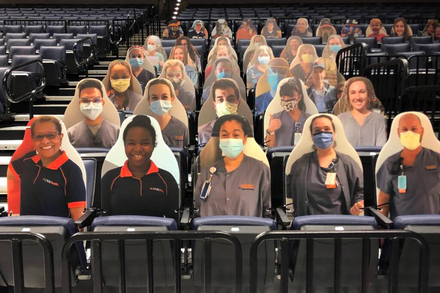 Cardboard cutouts of UVA Health Workers in John Paul Jones Arena Seats