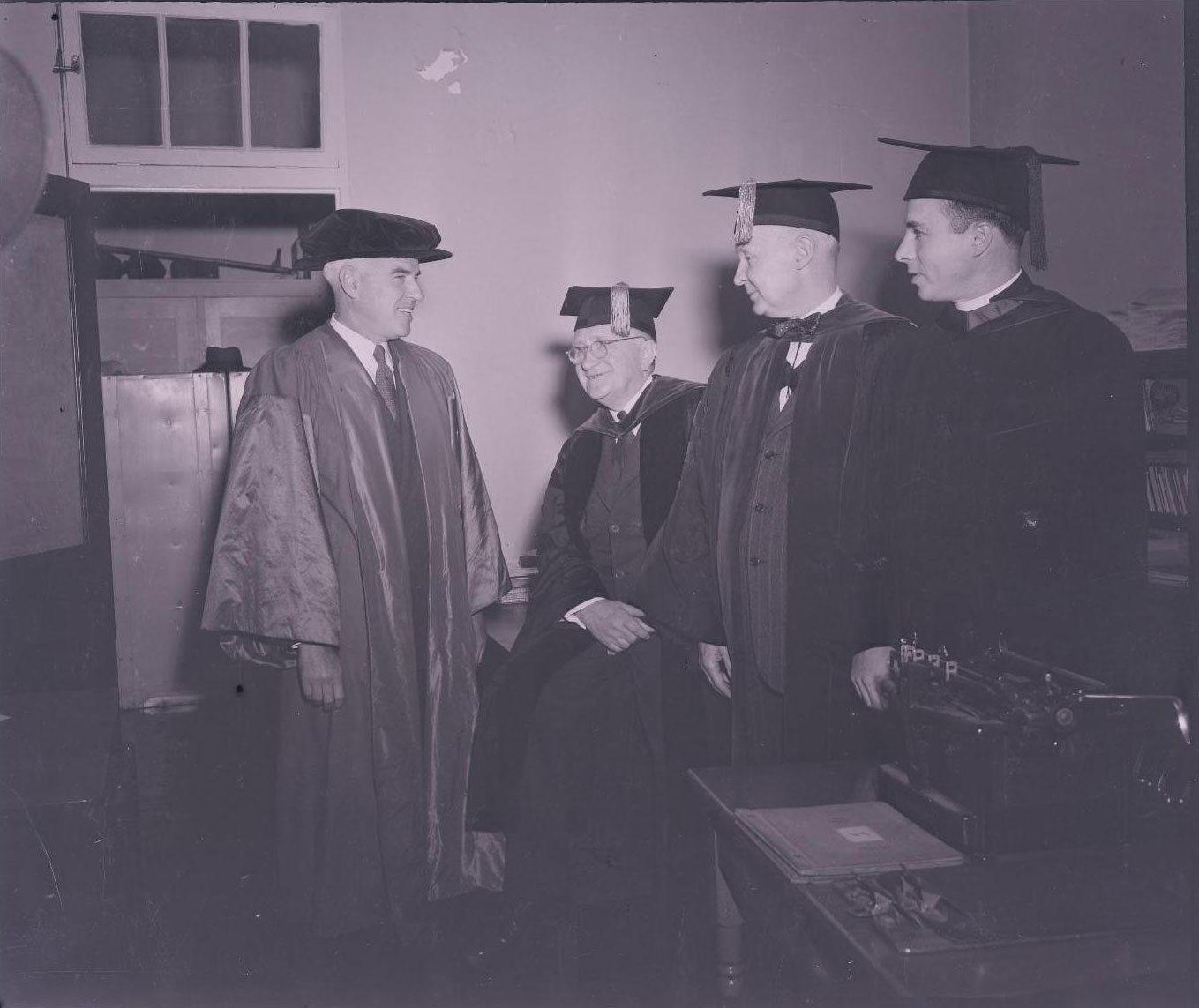 Rector Stettinius, left, in academic regalia on the Grounds at UVA.