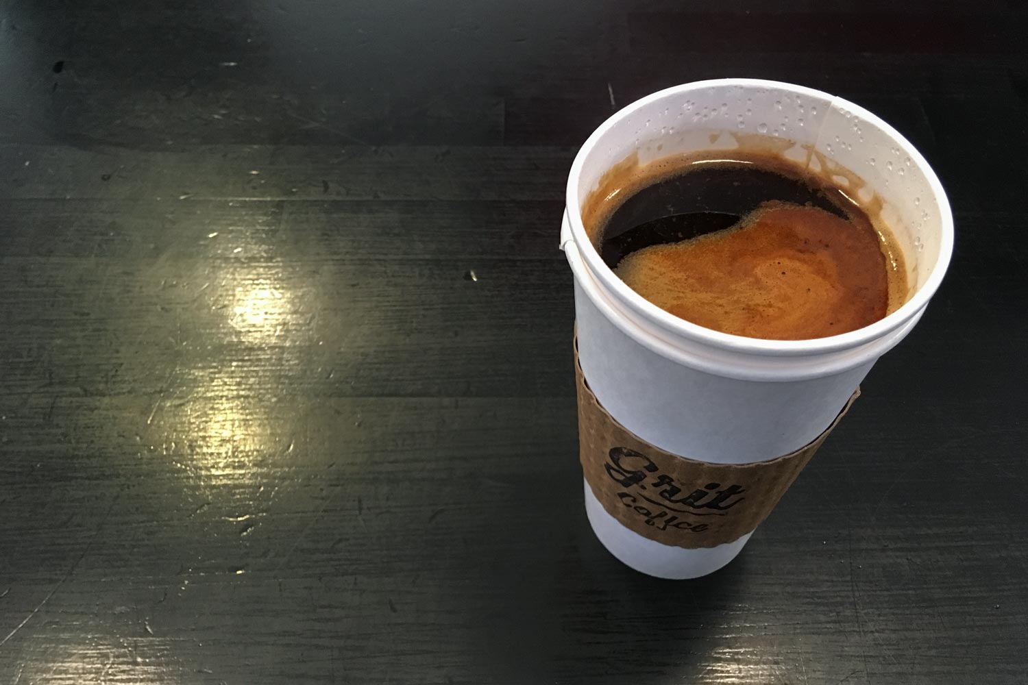 Coffee in a paper cup on a table