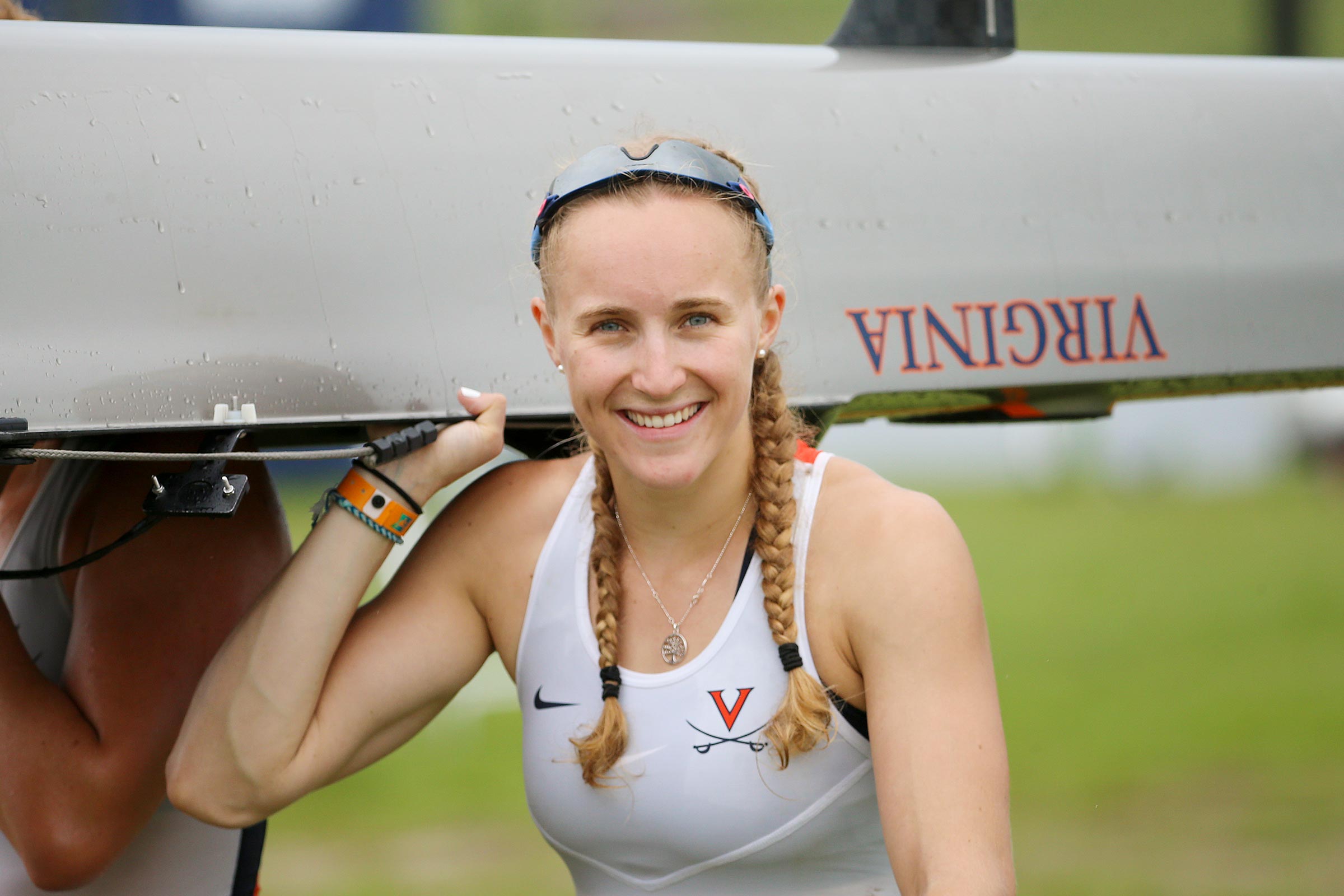 Heidi Long smiling while holding rowing canoe 