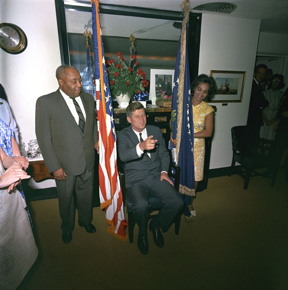 Thomas, left, with President Kennedy, center sitting, and Providencia “Provi” Paredes, right at a party