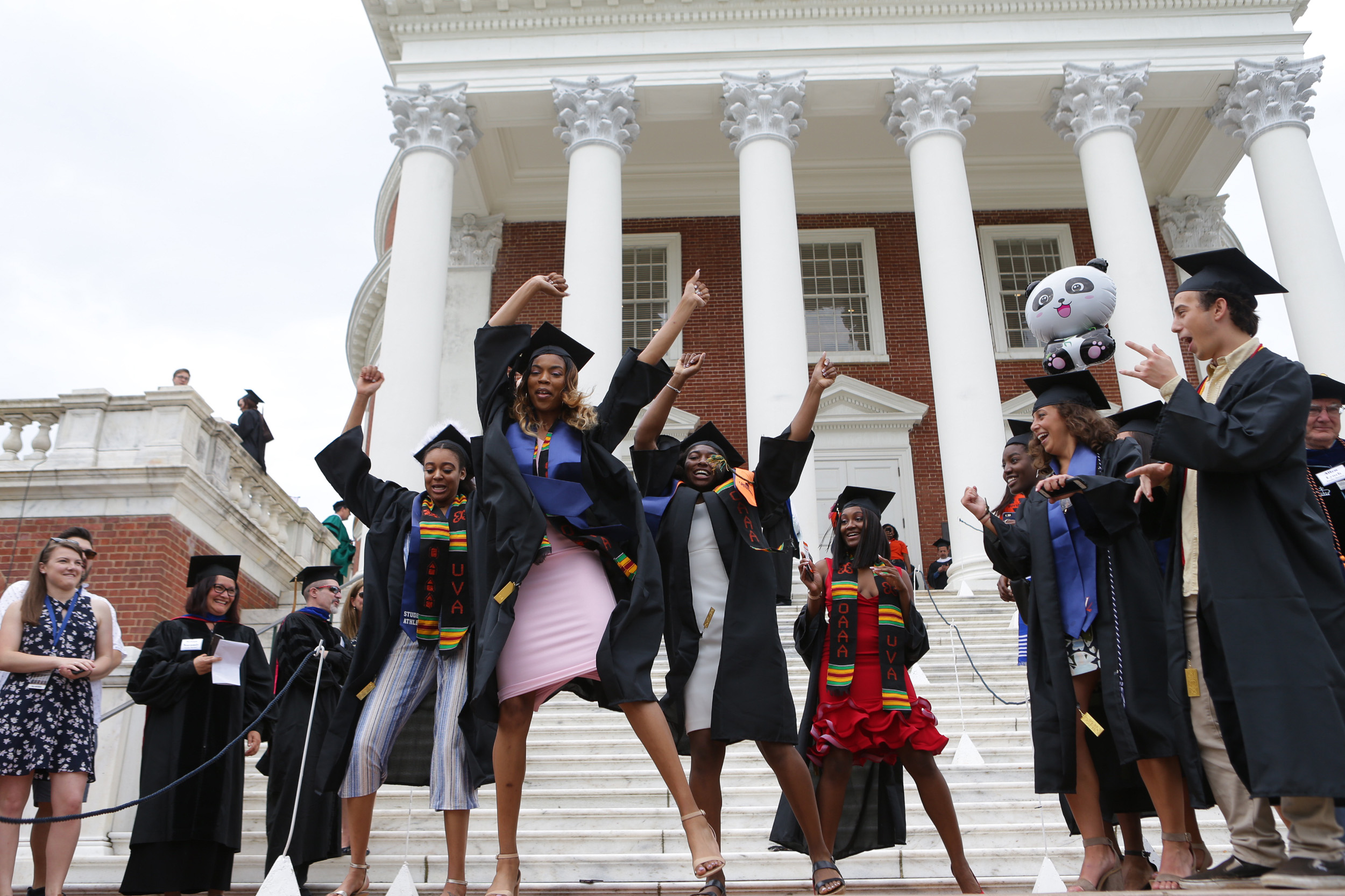 Students dance together in front of the Rotunda
