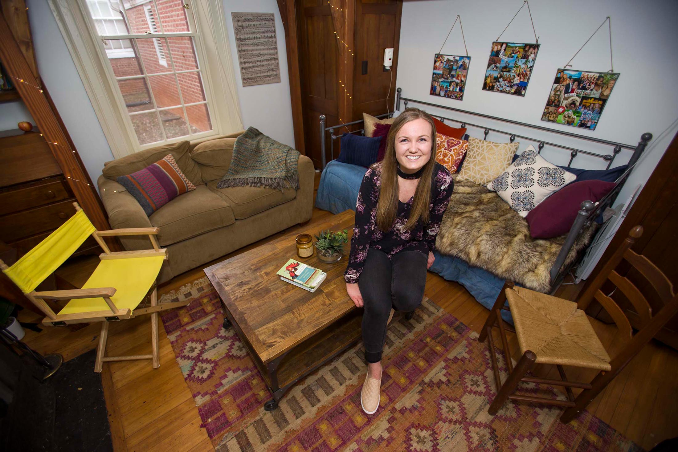 Juliana McCormick sits on a coffee table smiling at the camera