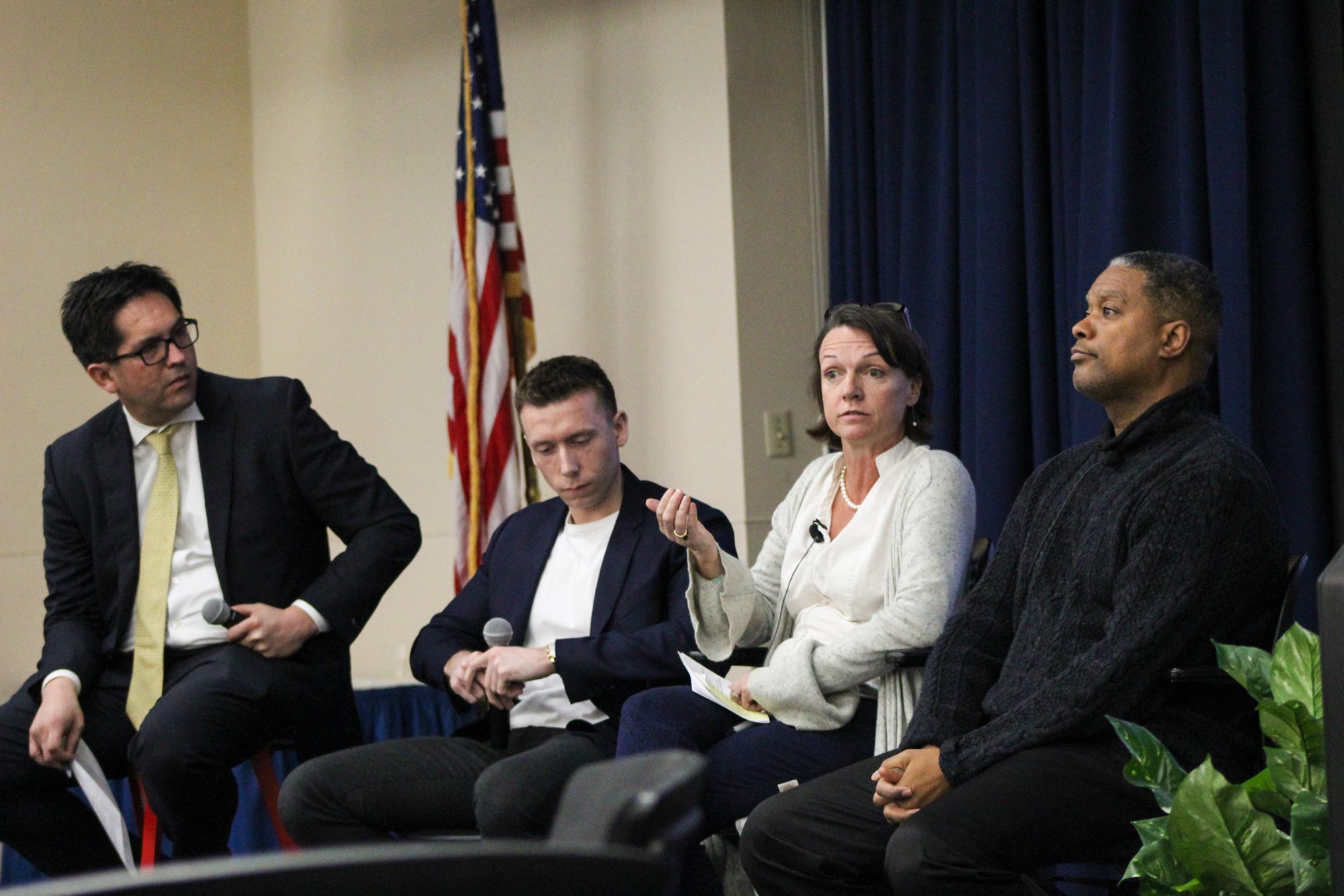From left: Dean Alex Hernandez, Josh Pritchett, Tierney Fairchild and Gerard Robinson sit on a stage talking