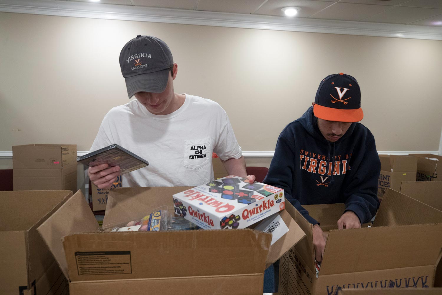 Andrew Rehr, left, and Michael Bassilios, right prepare boxes full of games