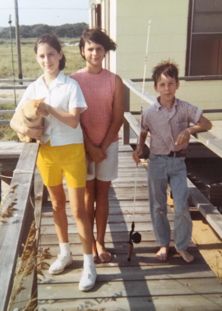 Jayne, Annette and Eddie standing on a peer with a dog